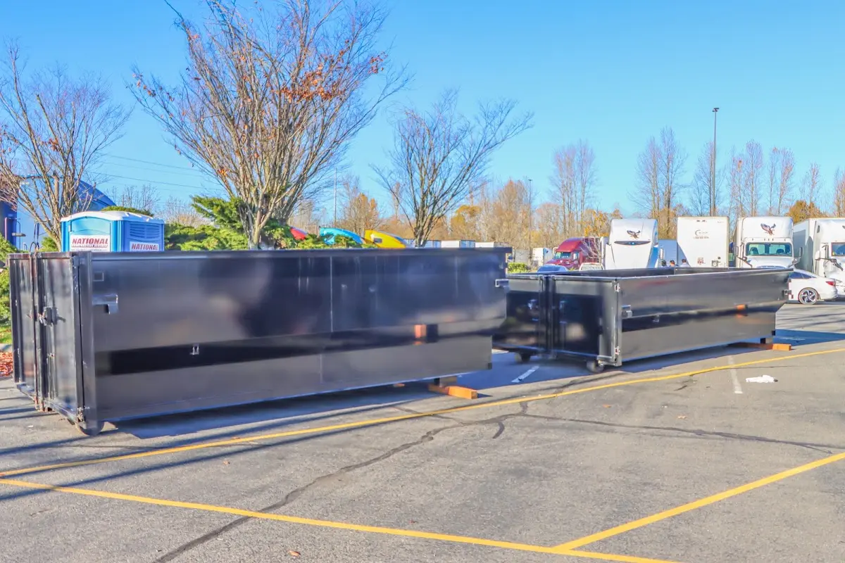 Professional dumpster rental service with roll-off container on residential driveway in Republic